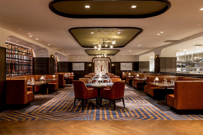 Elegant dining room with tufted banquettes set for dinner