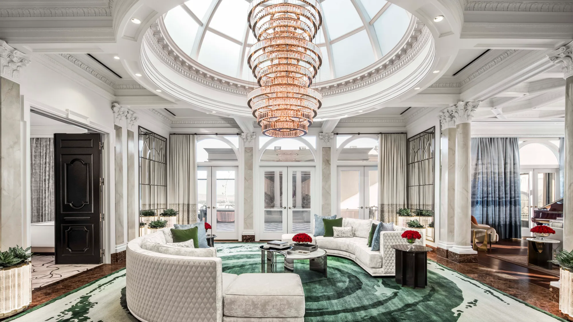 Opulent domed hotel suite living room with a crystal chandelier