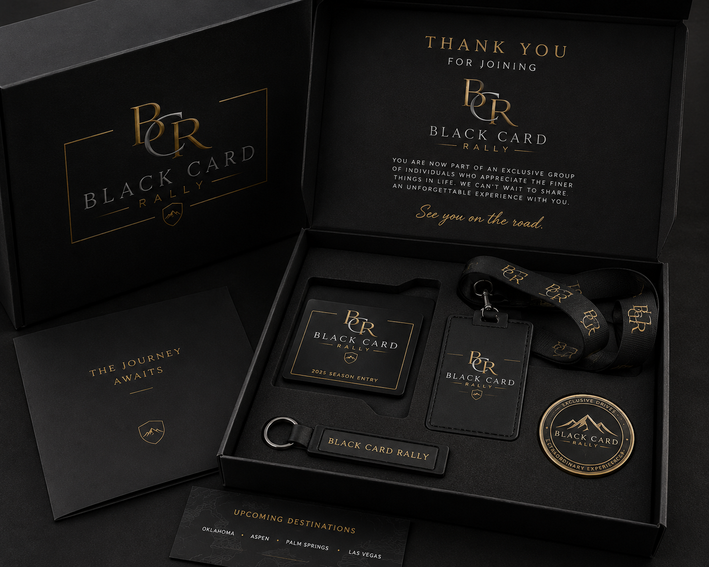Black Card Rally member welcome box with membership card, lanyard, keychain, and destination itinerary